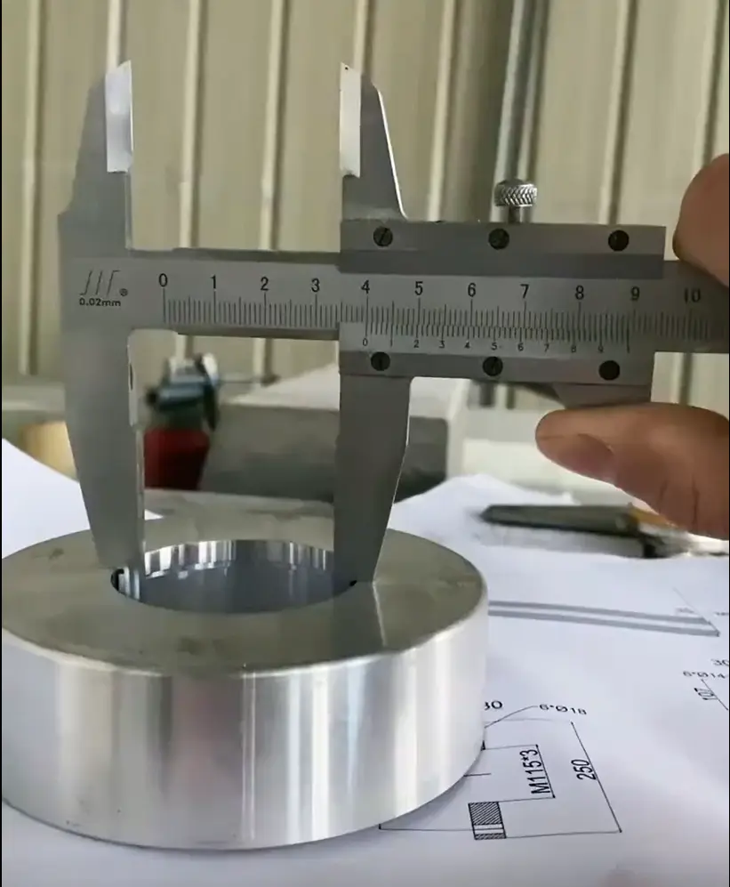 Technician using a caliper to measure stainless steel pipe wall thickness
